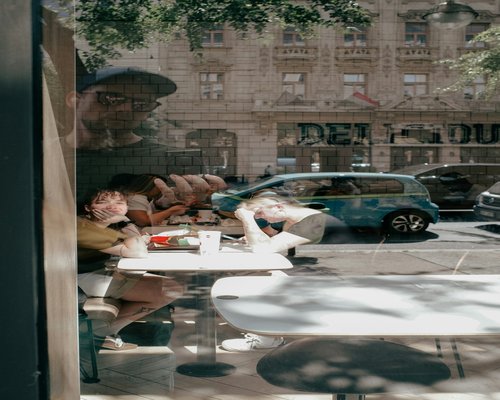 Man drinking water at a modern Budapest cafe